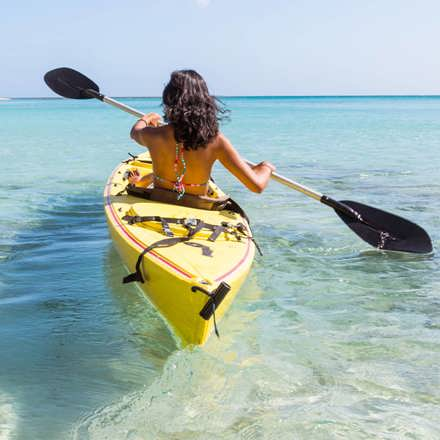 Instant Finance Travel Loan. Woman paddling a canoe