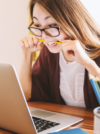 Woman on laptop choosing between a personal loan from Instant Finance and BNPL through Afterpay