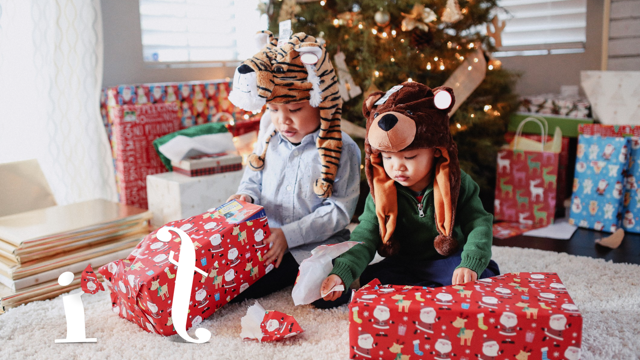 tow cute kids opening Christmas presents