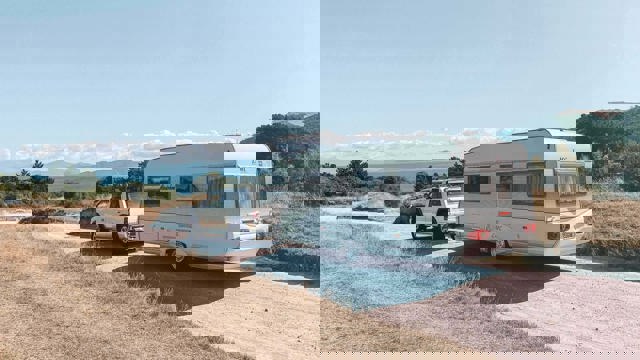 SUV towing a caravan on a gravel road, caravan finance, motorhome finance