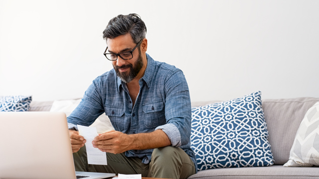 Man on laptop computer looking at his financial health