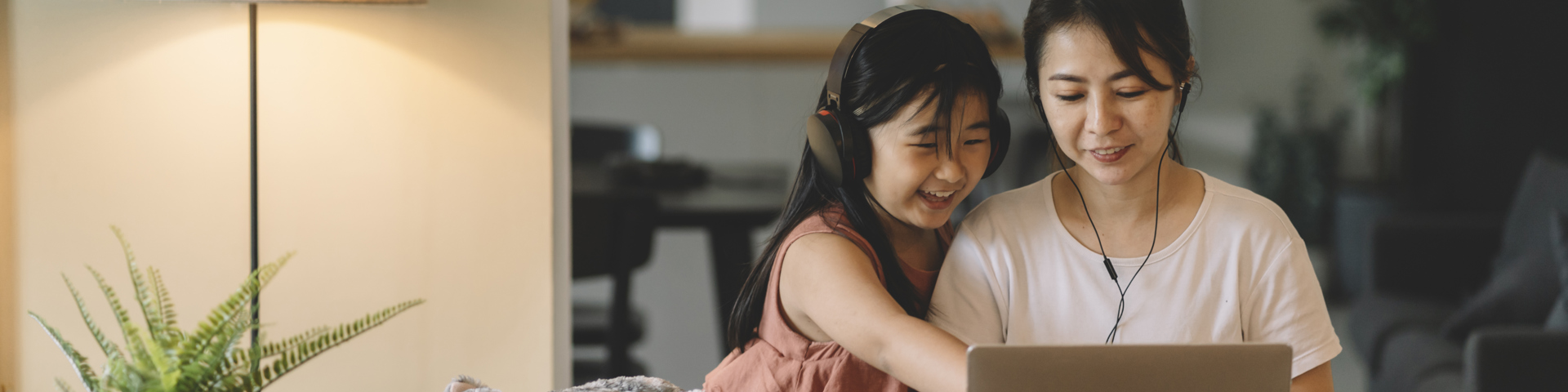 Woman on a computer with her daughter applying for personal student loans
