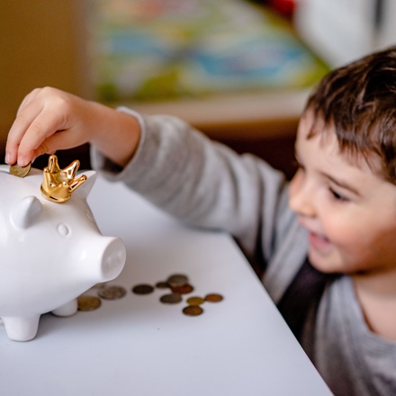 Entering money into a piggy bank for debt management, financial planning 