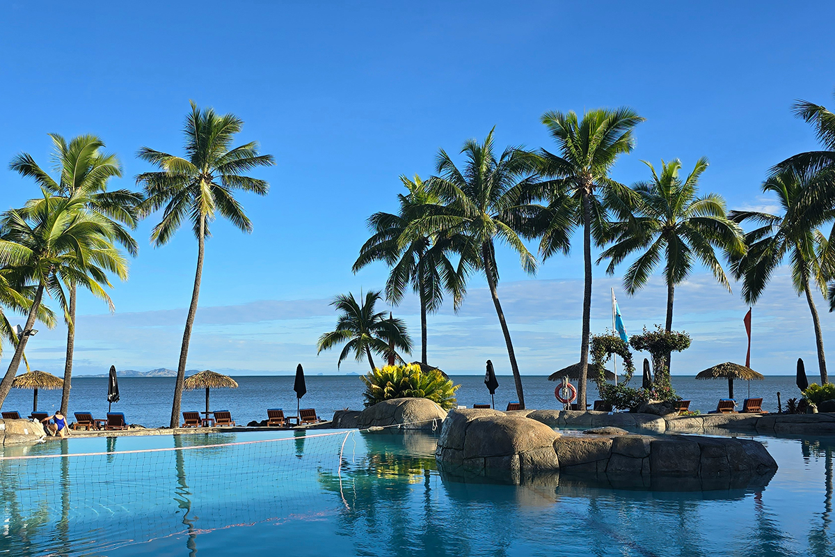 Turquoise water and a palm-lined beach on an island in Fiji